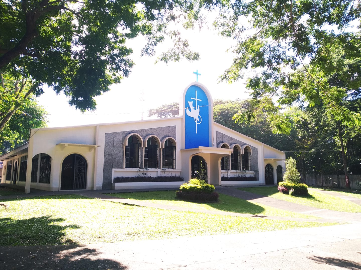 Beautiful church outside view with blue sky and green trees